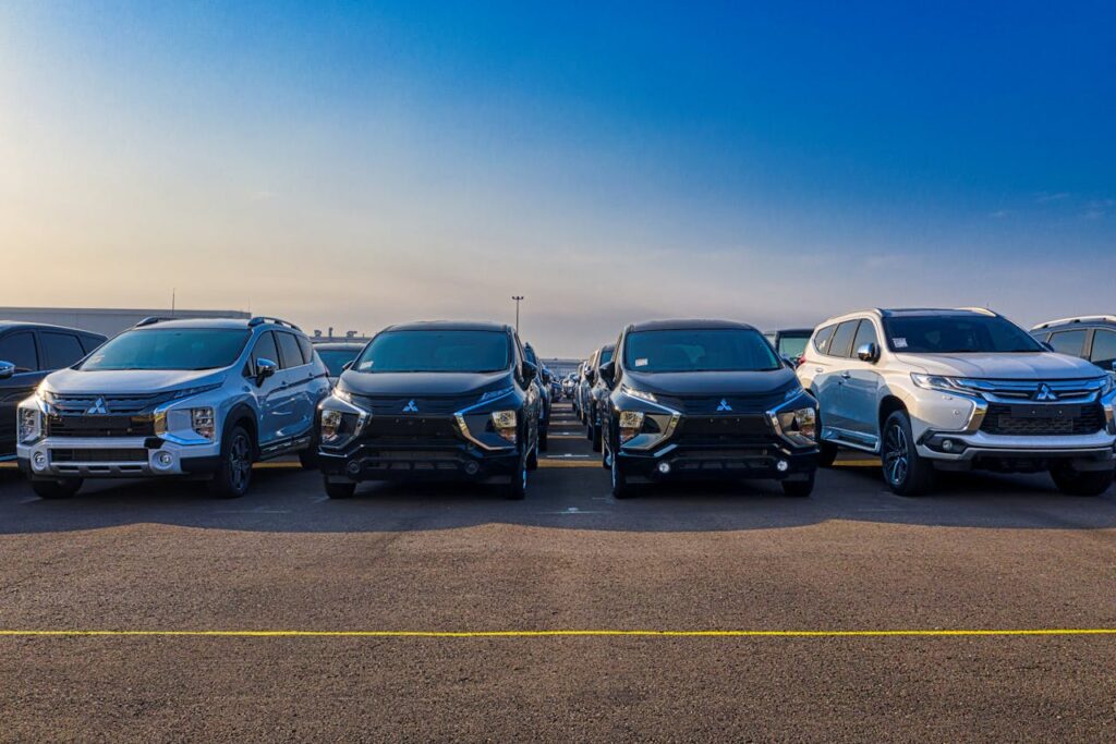Multiple SUVs parked outdoors under a clear blue sky. Modern and sleek automotive design.